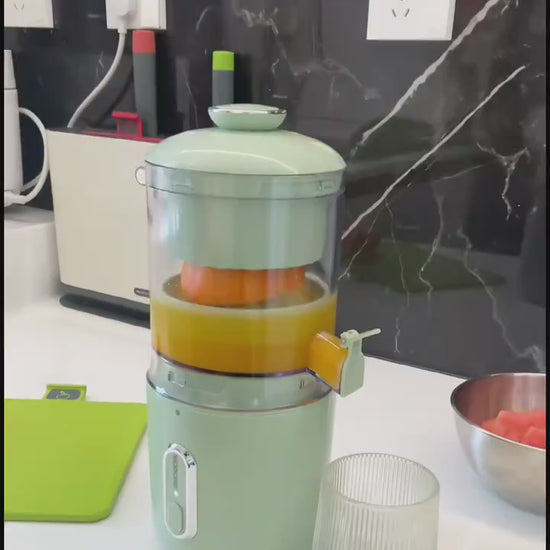 Person using a manual juicer to extract orange juice in a kitchen setting FRESH GREEN