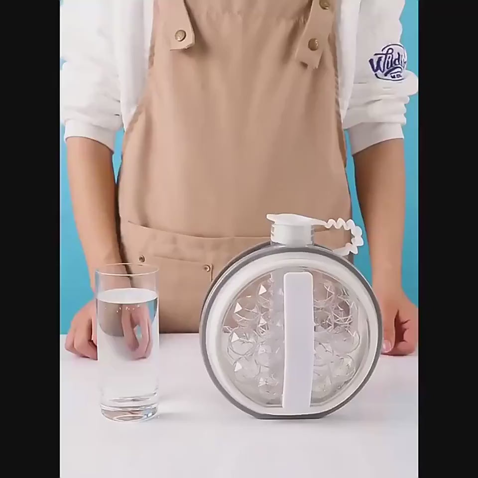 Person using a silicone mold to create ice cubes on a kitchen counter with fruits.