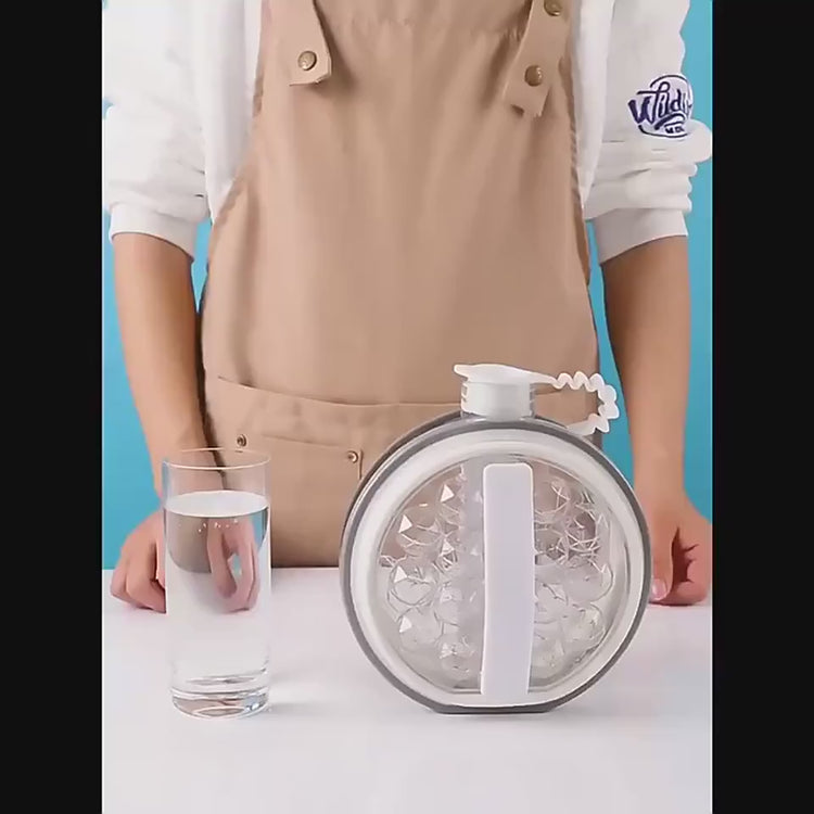 Person using a silicone mold to create ice cubes on a kitchen counter with fruits.