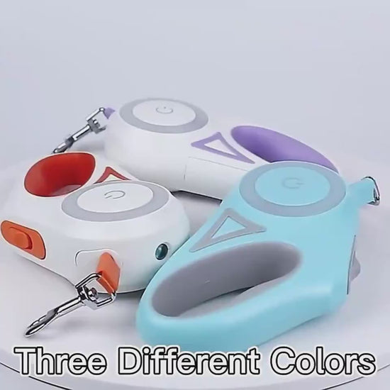 Three colorful retractable dog leashes on a pastel background with plants.