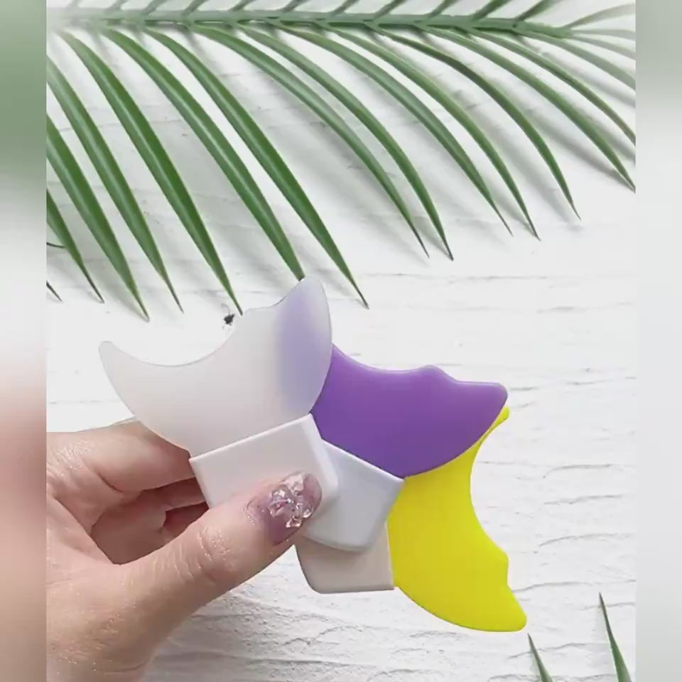 Pink and white hair tie holder on a beige background