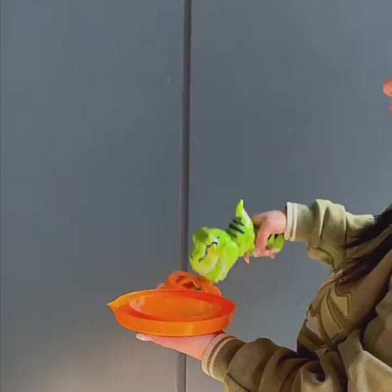 Green dinosaur-shaped bubble gun with bubbles in a grassy outdoor setting