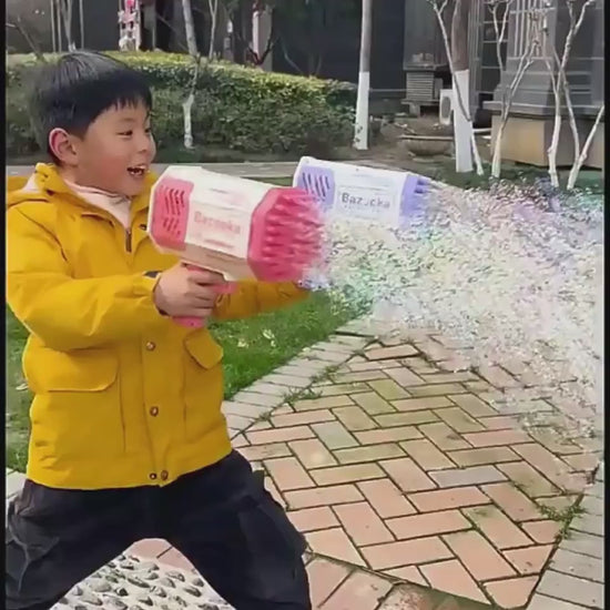 Bazooka bubble gun with bubbles in a park setting, including bubble solution and charger. Purple and Pink