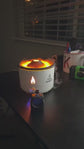 1.Two white flame-shaped lamps on a wooden surface with a blurred living room background.