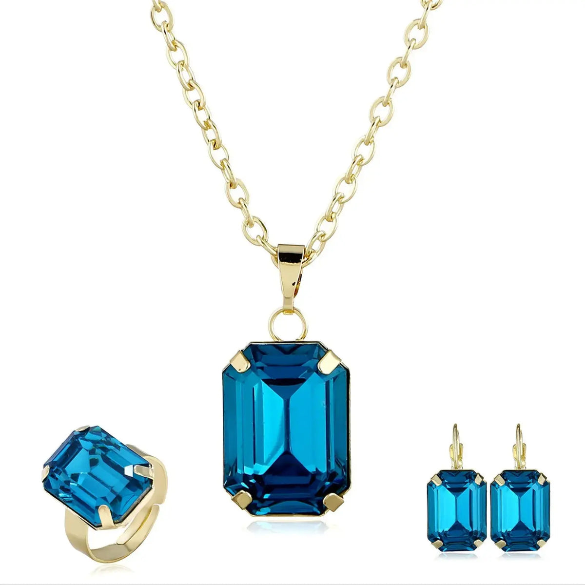 Elegant necklace earring set displaying deep blue rectangular gemstones and gold chain, displayed with matching ring.