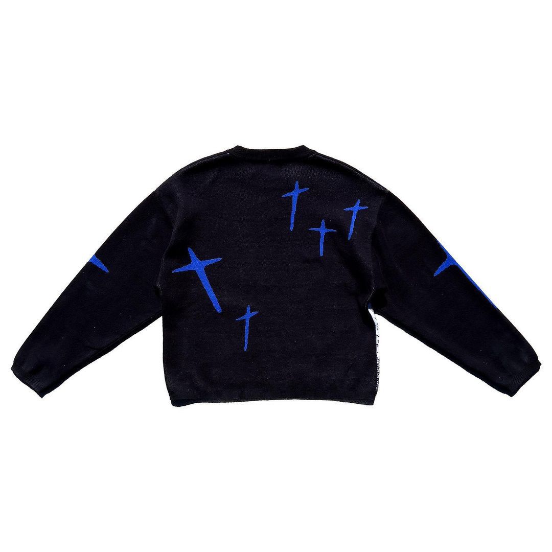 Women's printed pullover sweater with long sleeves, black with blue crosses, back view